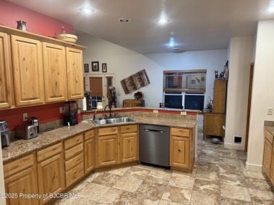 Quality home on the 11th fairway featuring 12 foot ceilings, gas on San Juan Country Club in New Mexico - for sale on GolfHomes.com, golf home, golf lot