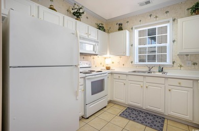 Two-bedroom two bath fully furnished second floor end unit in on Barefoot Resort and Golf Club  in South Carolina - for sale on GolfHomes.com, golf home, golf lot