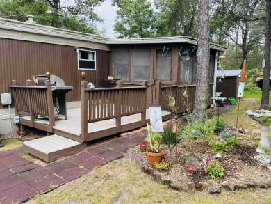Welcome to your Lake Arrowhead getaway! This charming mobile on Sand Valley Golf Course in Wisconsin - for sale on GolfHomes.com, golf home, golf lot