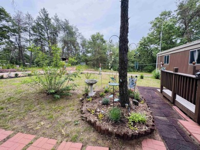 Welcome to your Lake Arrowhead getaway! This charming mobile on Sand Valley Golf Course in Wisconsin - for sale on GolfHomes.com, golf home, golf lot