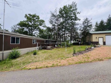 Welcome to your Lake Arrowhead getaway! This charming mobile on Sand Valley Golf Course in Wisconsin - for sale on GolfHomes.com, golf home, golf lot