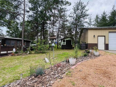 Welcome to your Lake Arrowhead getaway! This charming mobile on Sand Valley Golf Course in Wisconsin - for sale on GolfHomes.com, golf home, golf lot