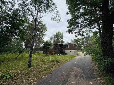 Welcome to your Lake Arrowhead getaway! This charming mobile on Sand Valley Golf Course in Wisconsin - for sale on GolfHomes.com, golf home, golf lot