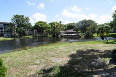BEAUTIFUL 2 BED, 2 BATH FIRST FLOOR CONDO W GORGEOUS WATER VIEWS on Pine Island Ridge Country Club in Florida - for sale on GolfHomes.com, golf home, golf lot