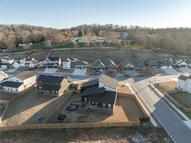 Modern design meets luxury living in this impressive 4-bedroom on Big Sugar Golf Club in Arkansas - for sale on GolfHomes.com, golf home, golf lot