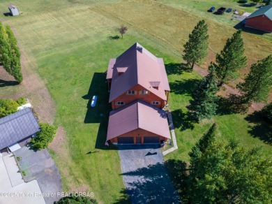 This beautiful log home combines rustic charm with modern on Star Valley RV Golf Course in Wyoming - for sale on GolfHomes.com, golf home, golf lot