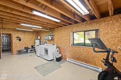 This beautiful log home combines rustic charm with modern on Star Valley RV Golf Course in Wyoming - for sale on GolfHomes.com, golf home, golf lot