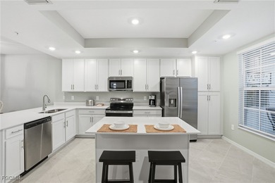 Wake up to shimmering water views and end every day with on Heritage Landing Golf  in Florida - for sale on GolfHomes.com, golf home, golf lot