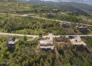 Perched on a scenic ridge with sweeping views of open space on Headwaters Golf Course At Granby Ranch in Colorado - for sale on GolfHomes.com, golf home, golf lot