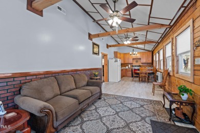 CHARMING LOG CABIN STYLE BUILD-OVER SITS PRETTY ON TRIPLE LOT!!! on River Golf and Country Club at Lake Royale in North Carolina - for sale on GolfHomes.com, golf home, golf lot