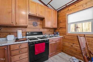 CHARMING LOG CABIN STYLE BUILD-OVER SITS PRETTY ON TRIPLE LOT!!! on River Golf and Country Club at Lake Royale in North Carolina - for sale on GolfHomes.com, golf home, golf lot