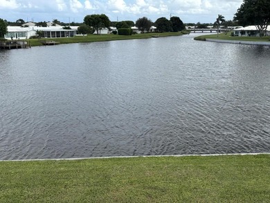 Enjoy expansive, picturesque water views from this completely on Leisureville Community Golf Course in Florida - for sale on GolfHomes.com, golf home, golf lot
