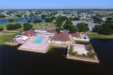 2022 Model home features accordion hurricane shutters, double on Barefoot Bay Golf Course in Florida - for sale on GolfHomes.com, golf home, golf lot