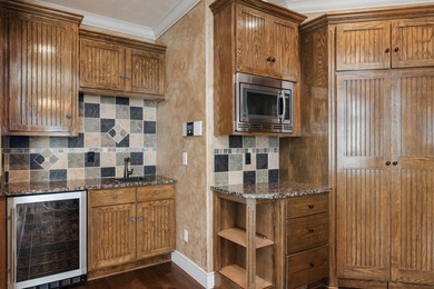 This 4 bed, 3.5 bath home is located in the San Poppi on Millwood Golf and Racquet Club in Missouri - for sale on GolfHomes.com, golf home, golf lot