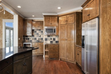 This 4 bed, 3.5 bath home is located in the San Poppi on Millwood Golf and Racquet Club in Missouri - for sale on GolfHomes.com, golf home, golf lot