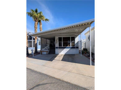 Perfect snowbird retreat. The enclosed patio offers extra room on Riverview Golf Course in Arizona - for sale on GolfHomes.com, golf home, golf lot