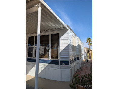 Perfect snowbird retreat. The enclosed patio offers extra room on Riverview Golf Course in Arizona - for sale on GolfHomes.com, golf home, golf lot