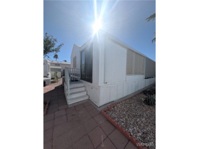 Perfect snowbird retreat. The enclosed patio offers extra room on Riverview Golf Course in Arizona - for sale on GolfHomes.com, golf home, golf lot