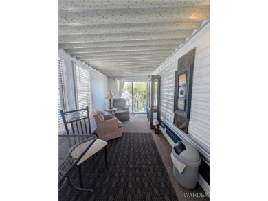 Perfect snowbird retreat. The enclosed patio offers extra room on Riverview Golf Course in Arizona - for sale on GolfHomes.com, golf home, golf lot