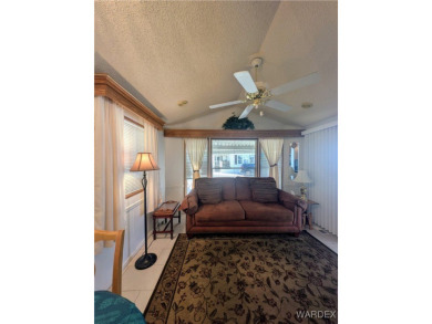 Perfect snowbird retreat. The enclosed patio offers extra room on Riverview Golf Course in Arizona - for sale on GolfHomes.com, golf home, golf lot