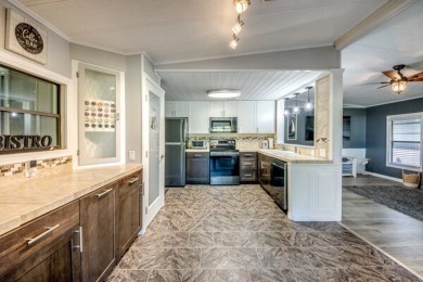This unique two-bedroom, two-bath home in the gated, golf-course on Lake Fairways Country Club in Florida - for sale on GolfHomes.com, golf home, golf lot