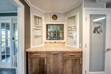 This unique two-bedroom, two-bath home in the gated, golf-course on Lake Fairways Country Club in Florida - for sale on GolfHomes.com, golf home, golf lot