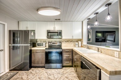This unique two-bedroom, two-bath home in the gated, golf-course on Lake Fairways Country Club in Florida - for sale on GolfHomes.com, golf home, golf lot