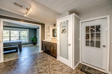 This unique two-bedroom, two-bath home in the gated, golf-course on Lake Fairways Country Club in Florida - for sale on GolfHomes.com, golf home, golf lot