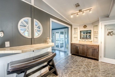 This unique two-bedroom, two-bath home in the gated, golf-course on Lake Fairways Country Club in Florida - for sale on GolfHomes.com, golf home, golf lot