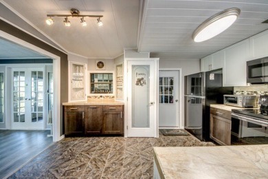 This unique two-bedroom, two-bath home in the gated, golf-course on Lake Fairways Country Club in Florida - for sale on GolfHomes.com, golf home, golf lot
