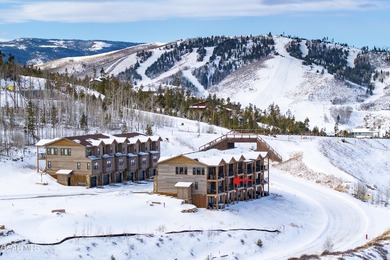 This luxurious townhome can be seen rising above the Granby on Headwaters Golf Course At Granby Ranch in Colorado - for sale on GolfHomes.com, golf home, golf lot