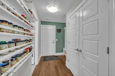 Experience luxury in this exquisite 3-bedroom, 3-bath all-brick on Cape Fear National At Brunswick Forest in North Carolina - for sale on GolfHomes.com, golf home, golf lot