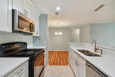 Spacious END UNIT with 3 bedrooms and 2 full bathrooms WITH A on Hunters Green Country Club in Florida - for sale on GolfHomes.com, golf home, golf lot