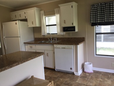Great view from the kitchen and living room of this nicely on Spanish Lakes I in Florida - for sale on GolfHomes.com, golf home, golf lot