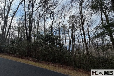This prime building site offers potential mountain views of the on Sapphire National Golf Club in North Carolina - for sale on GolfHomes.com, golf home, golf lot