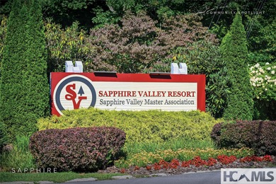 This prime building site offers potential mountain views of the on Sapphire National Golf Club in North Carolina - for sale on GolfHomes.com, golf home, golf lot
