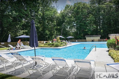 This prime building site offers potential mountain views of the on Sapphire National Golf Club in North Carolina - for sale on GolfHomes.com, golf home, golf lot