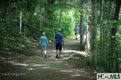 This prime building site offers potential mountain views of the on Sapphire National Golf Club in North Carolina - for sale on GolfHomes.com, golf home, golf lot
