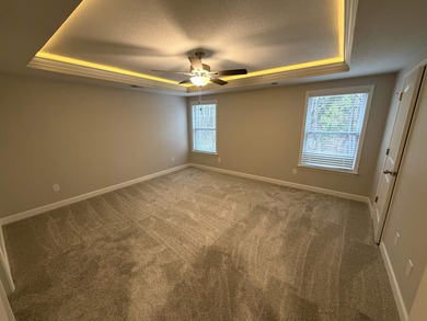 The Ridge plan! The primary suite, laundry, and living area fill on Woodfin Ridge Golf Club in South Carolina - for sale on GolfHomes.com, golf home, golf lot