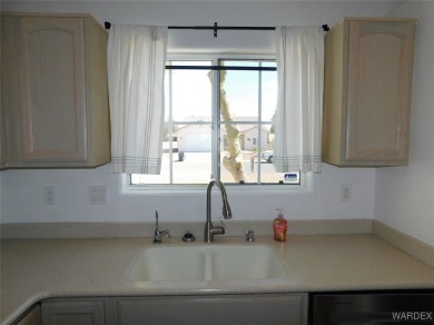 Discover this stunning 3-bedroom, 2-bath home located on a on Desert Lakes Golf Course in Arizona - for sale on GolfHomes.com, golf home, golf lot