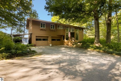 Nestled high among the woods, this lovely residence offers on Crystal Downs Country Club in Michigan - for sale on GolfHomes.com, golf home, golf lot