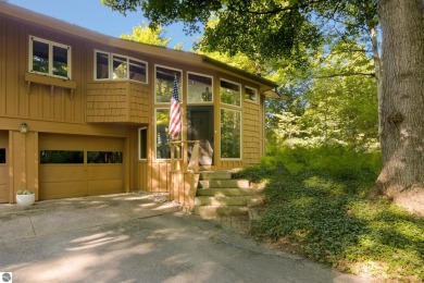 Nestled high among the woods, this lovely residence offers on Crystal Downs Country Club in Michigan - for sale on GolfHomes.com, golf home, golf lot