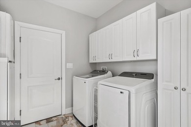 The welcoming covered entry of 33418 Islander Drive invites you on The Peninsula Golf and Country Club in Delaware - for sale on GolfHomes.com, golf home, golf lot