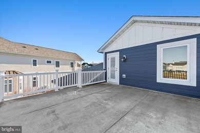 The welcoming covered entry of 33418 Islander Drive invites you on The Peninsula Golf and Country Club in Delaware - for sale on GolfHomes.com, golf home, golf lot