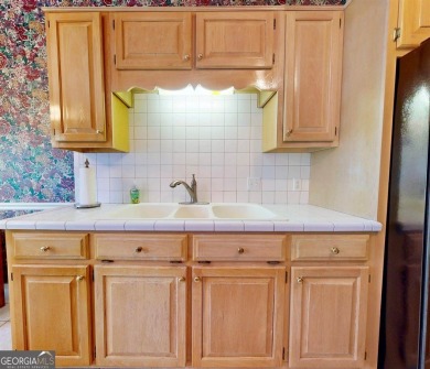 Imagine mornings on your spacious covered front porch or on Okefenokee Country Club in Georgia - for sale on GolfHomes.com, golf home, golf lot