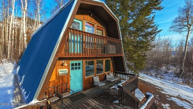 Nestled among a serene canopy of mature trees, this charming on Star Valley RV Golf Course in Wyoming - for sale on GolfHomes.com, golf home, golf lot