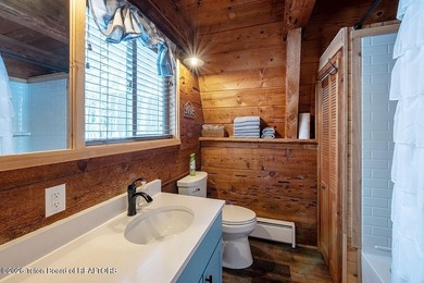 Nestled among a serene canopy of mature trees, this charming on Star Valley RV Golf Course in Wyoming - for sale on GolfHomes.com, golf home, golf lot