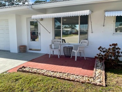 This is a 2-bedroom, 2-bathroom home with a 1-car garage on Mainlands Golf Club in Florida - for sale on GolfHomes.com, golf home, golf lot