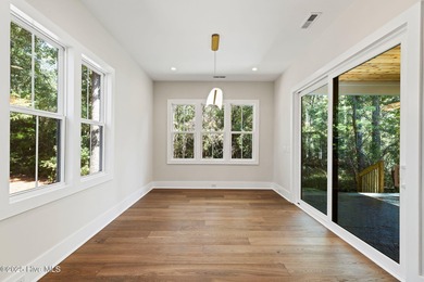 Stunning new construction in the desirable and gated community on Carolina National Golf Club in North Carolina - for sale on GolfHomes.com, golf home, golf lot