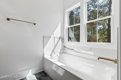 Stunning new construction in the desirable and gated community on Carolina National Golf Club in North Carolina - for sale on GolfHomes.com, golf home, golf lot